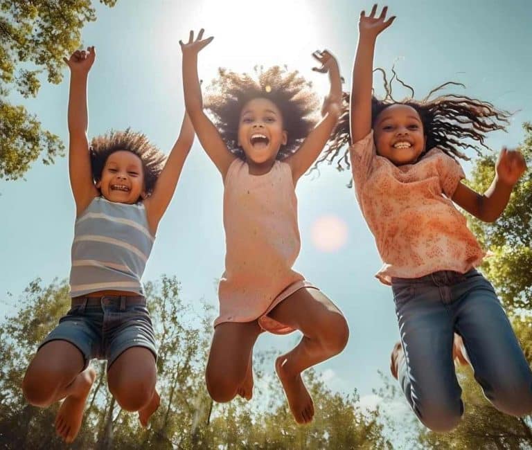 a dark auditorium full of people watching speakers debate on a stage.